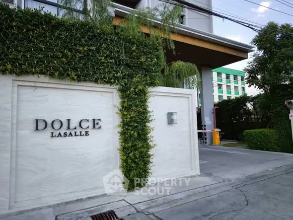 Modern condominium entrance with lush greenery and stylish signage at Dolce Lasalle.