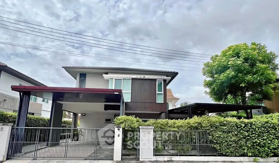 Modern two-story house with spacious driveway and lush greenery