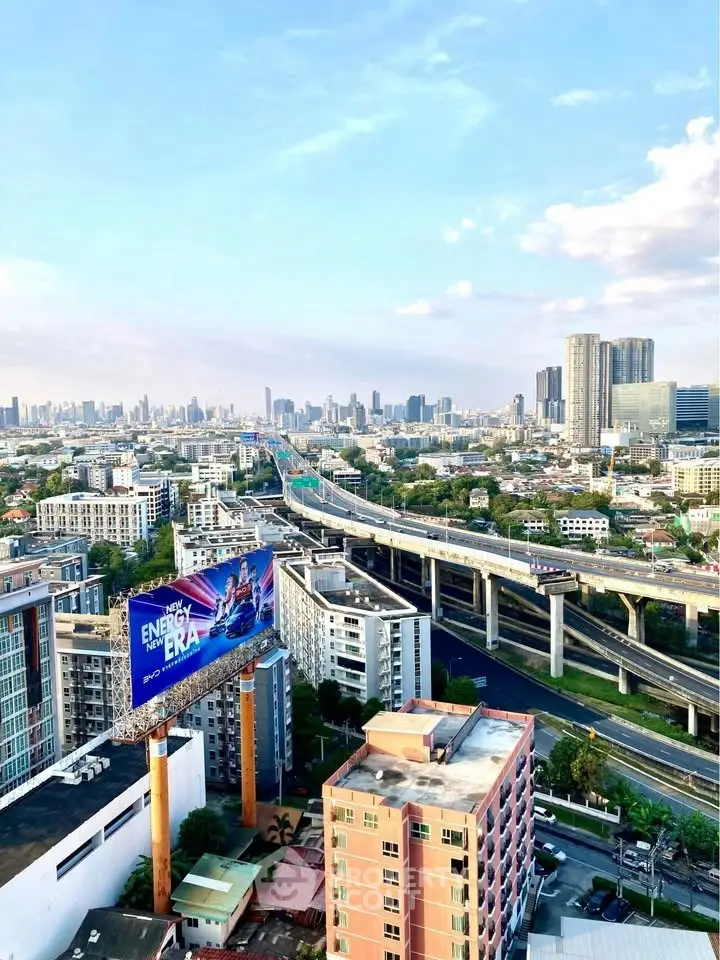 Stunning cityscape view from high-rise building with expansive skyline and highway.