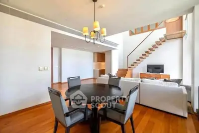 Spacious modern living room with wooden flooring and elegant staircase