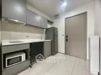 Modern compact kitchen with sleek cabinets and appliances in a stylish apartment