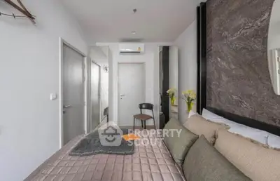 Modern bedroom with stylish decor and air conditioning in a cozy apartment.