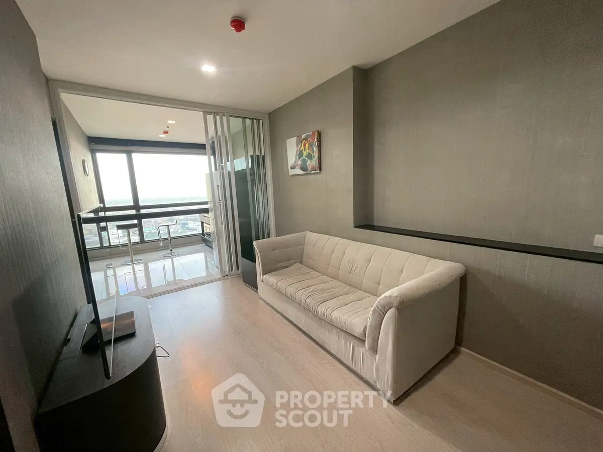 Modern living room with balcony and stunning view, featuring sleek furniture and stylish decor.