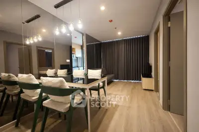 Modern living room with stylish dining area and elegant lighting