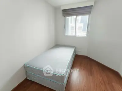 Cozy minimalist bedroom with single bed and wooden flooring