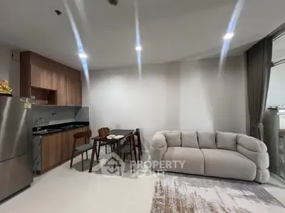 Modern open-layout living room with cozy sofa and dining area in stylish apartment.