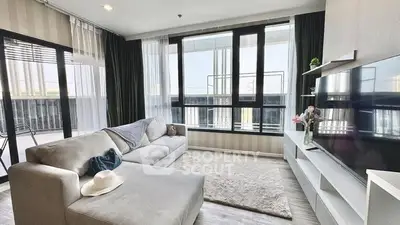 Spacious modern living room with large windows and cozy sectional sofa