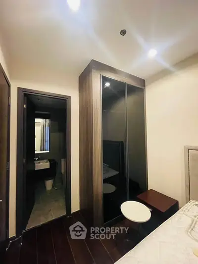 Modern bedroom with ensuite bathroom and sleek wardrobe design
