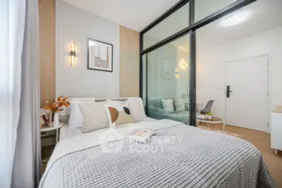 Modern bedroom with cozy decor and glass partition in stylish apartment