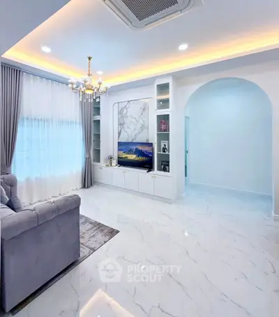 Elegant living room with marble flooring, modern chandelier, and built-in TV unit for luxurious living.