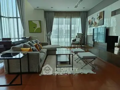 Luxurious modern living room with stylish decor and large windows offering abundant natural light.