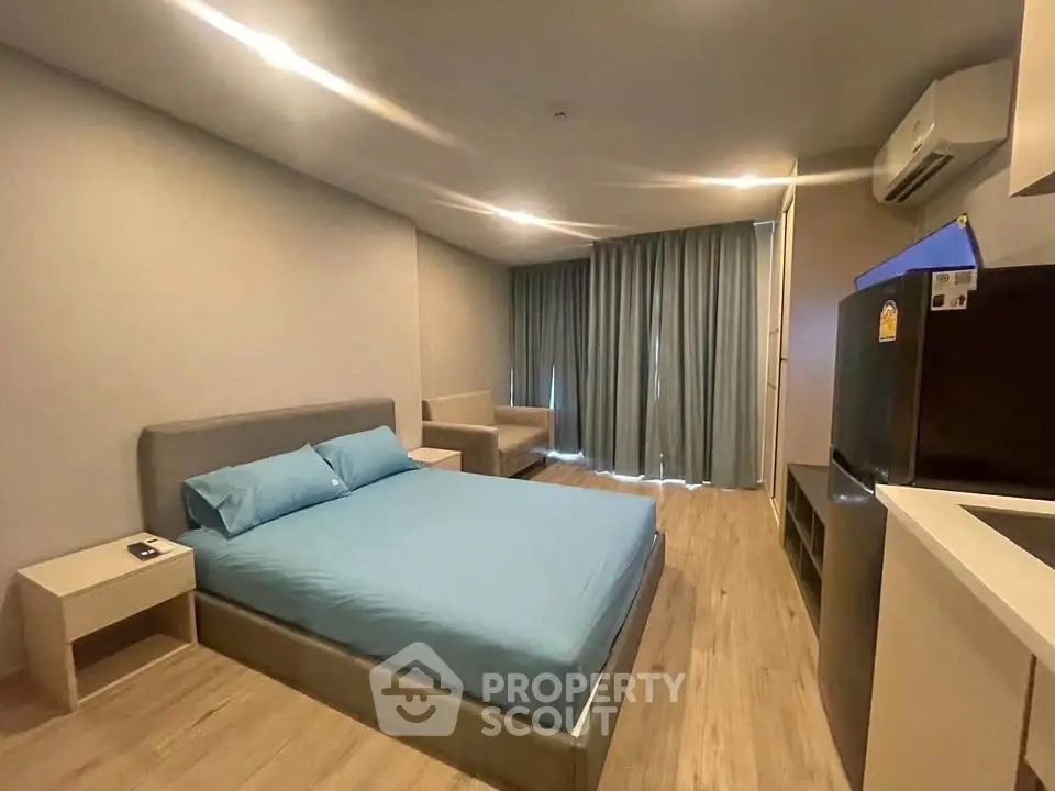Modern bedroom with cozy bed, air conditioning, and stylish decor in a contemporary apartment.