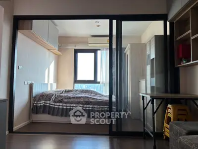 Modern bedroom with sliding glass doors and city view