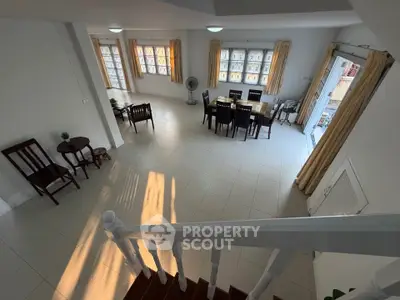 Spacious open-plan living and dining area with abundant natural light and elegant furnishings.