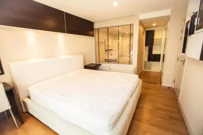 Spacious modern bedroom with elegant wooden flooring and stylish lighting