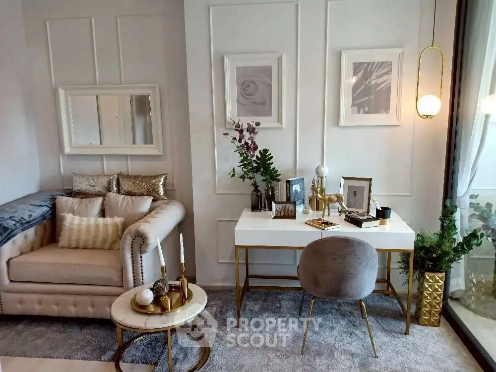 Elegant living room with plush sofa, stylish decor, and chic workspace by the window.