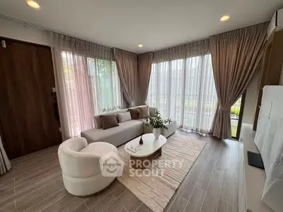 Elegant living room with modern furniture and large windows for natural light.