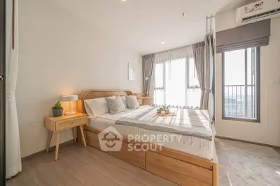 Bright and airy bedroom with modern wooden furniture and large windows offering stunning views.