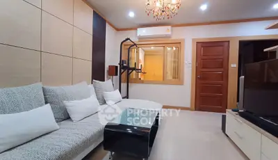 Modern living room with stylish sofa and elegant chandelier
