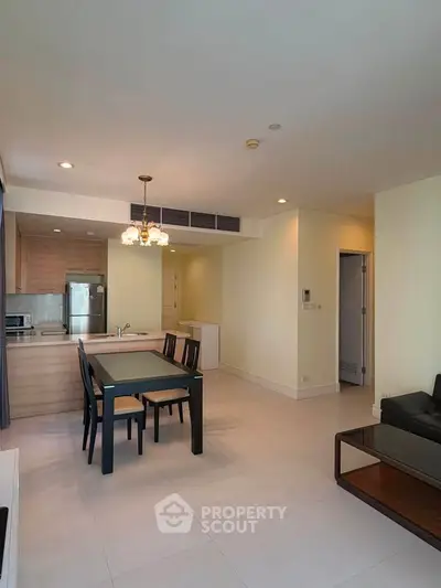 Spacious open-plan living and dining area with modern kitchen in a stylish apartment.