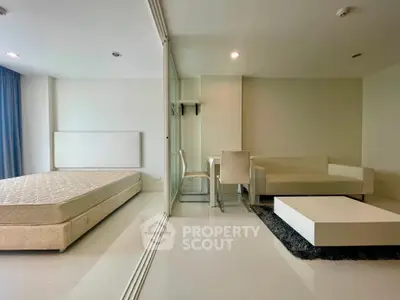 Modern studio apartment with sleek design, featuring a cozy living area and comfortable sleeping space.