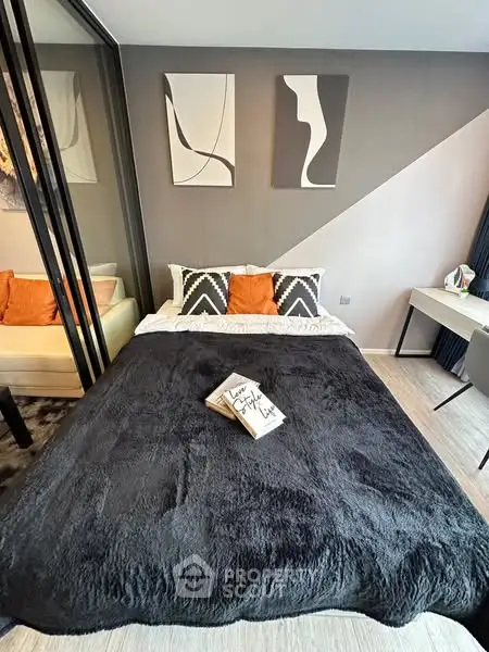 Modern bedroom with stylish decor and cozy bedding in a contemporary apartment.