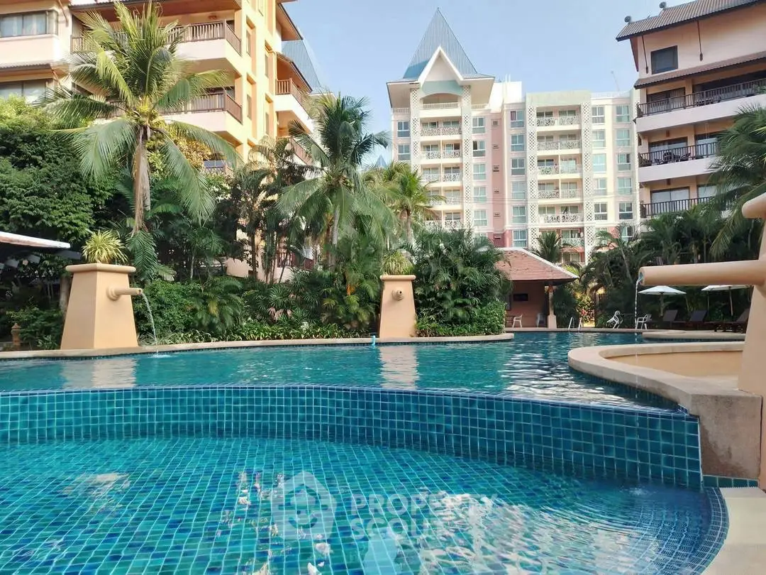 Luxurious residential complex with stunning pool and lush greenery, perfect for resort-style living.
