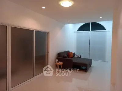 Modern living room with sleek design and cozy sofa, perfect for relaxation.