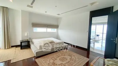 Spacious bedroom with modern decor and balcony access