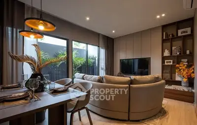Modern living room with stylish decor and large windows overlooking greenery.