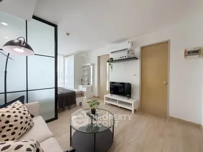 Modern living room with stylish decor and open layout, featuring a cozy seating area and sleek furnishings.