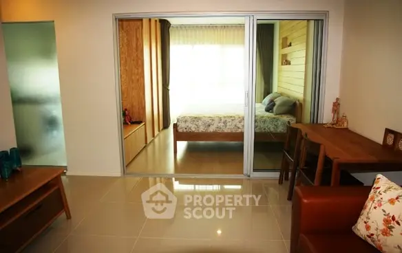 Modern apartment interior with sliding glass doors to bedroom and stylish decor