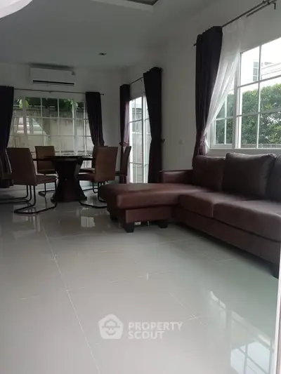 Spacious living room with modern furniture and large windows for natural light.