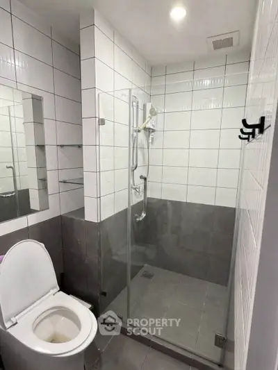 Modern bathroom with glass shower enclosure and sleek tile design