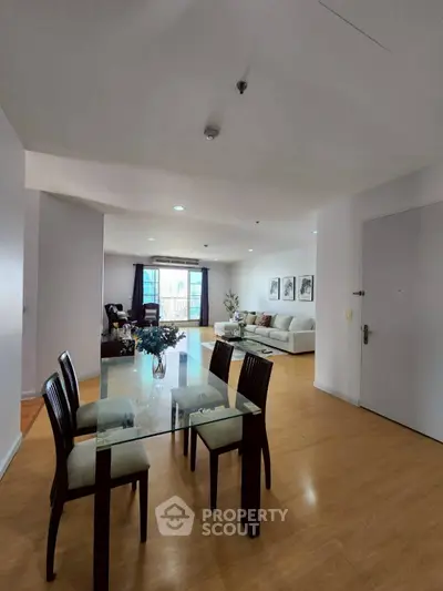 Spacious open-plan living and dining area with modern decor and natural light.