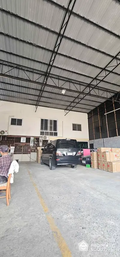 Spacious warehouse interior with high ceiling and ample storage space