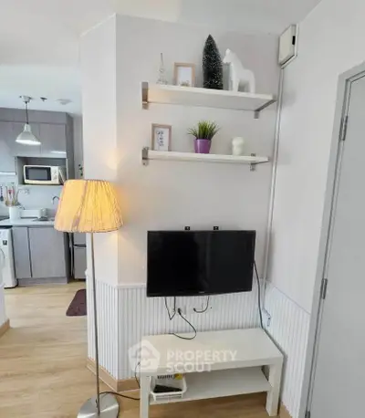 Modern living room with stylish decor and open kitchen layout, featuring a cozy ambiance and contemporary design.