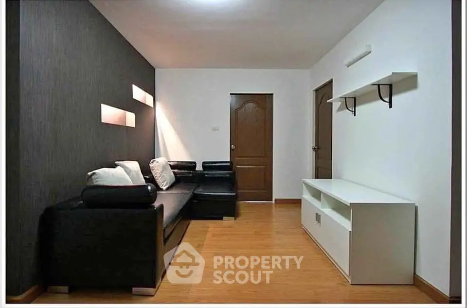 Modern living room with sleek black sofa and minimalist decor