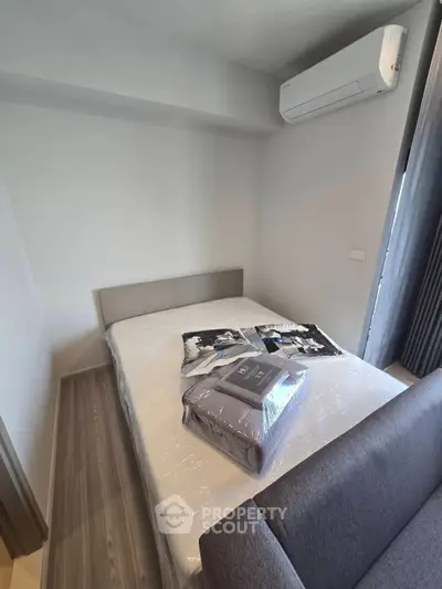 Cozy bedroom with air conditioning and modern decor, perfect for relaxation.