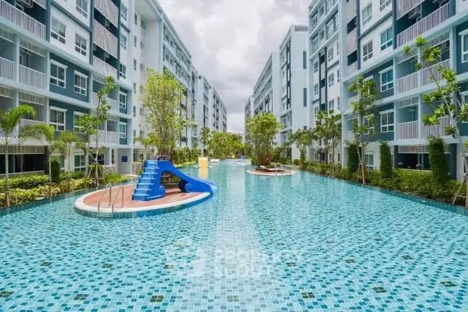 Luxurious apartment complex with stunning pool and lush greenery, perfect for modern living.