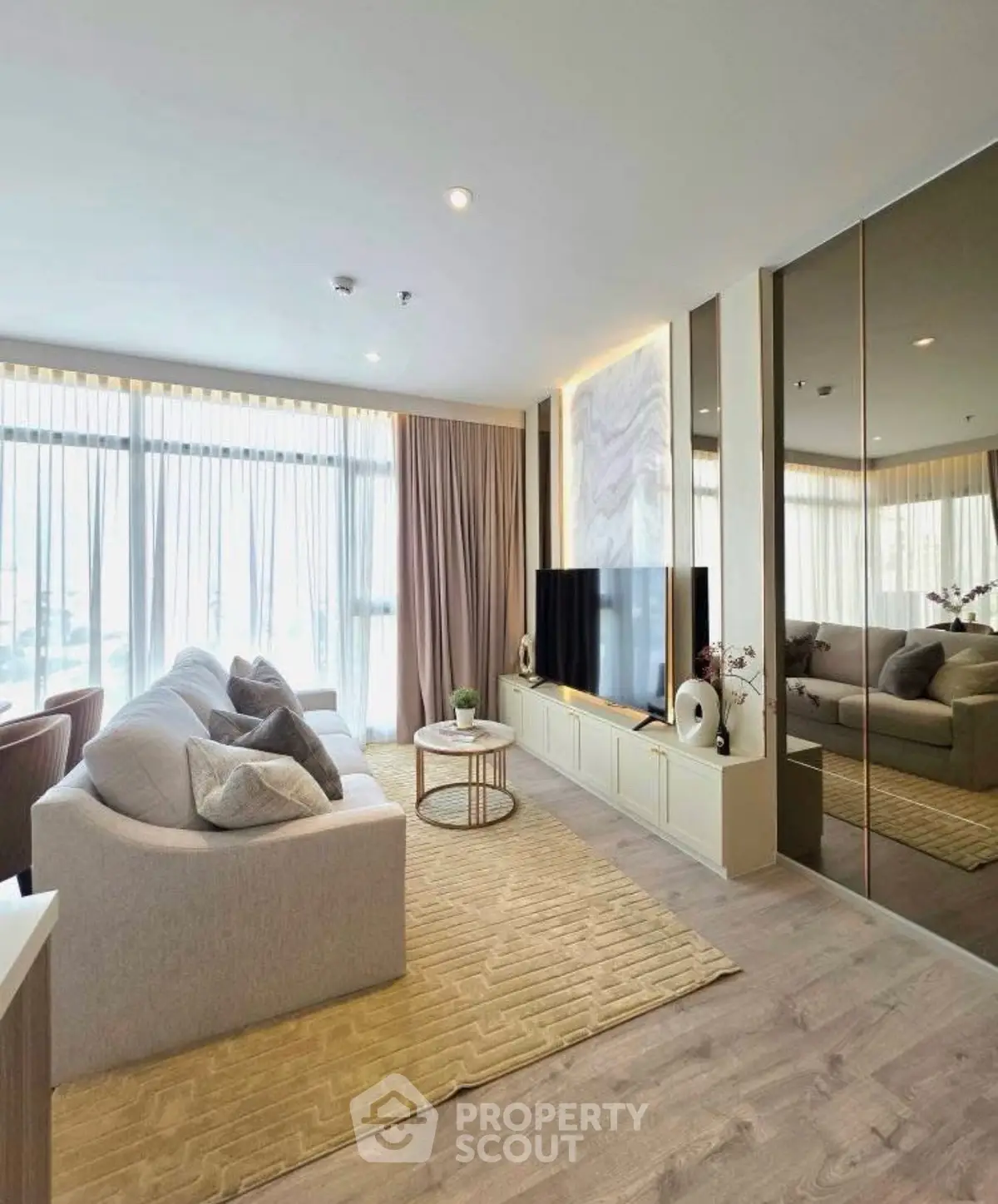 Luxurious living room with modern decor, large windows, and elegant furnishings.