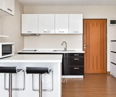 Modern kitchen with sleek cabinetry and breakfast bar in a stylish apartment.