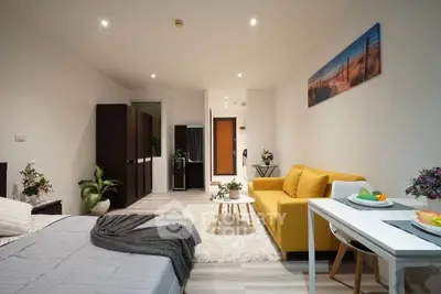 Modern studio apartment with cozy living area and stylish decor