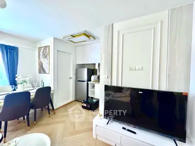 Modern living room with dining area and sleek kitchen appliances
