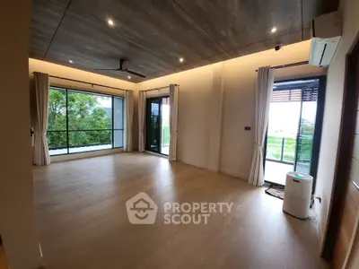 Spacious modern living room with large windows and scenic views