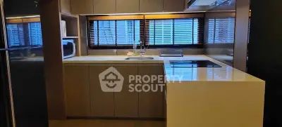 Modern kitchen with sleek cabinetry and large windows