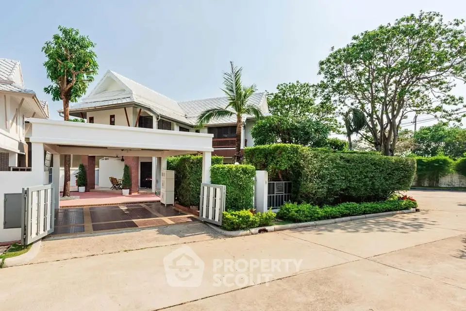 Charming suburban house with lush greenery and spacious driveway, perfect for family living.