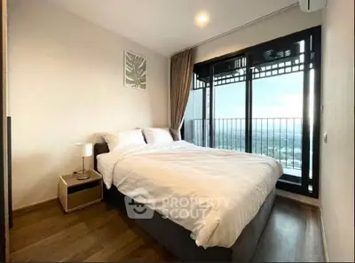 Modern bedroom with large window and stunning view in high-rise apartment