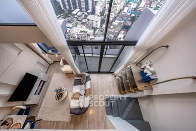 Stunning high-rise living room with floor-to-ceiling windows and breathtaking city view