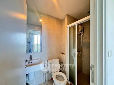 Modern bathroom with shower and sleek fixtures in a contemporary home.